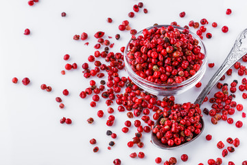 fragrant pink peppercorns on white acrylic background