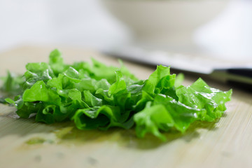Fresh green lettuce sliced on a cutting board. Healthy eating