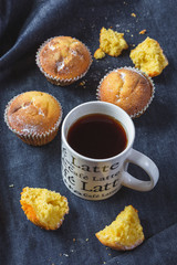 Muffins with coffee on dark background