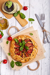 Quiche open tart pie with tomatoes, eggplant and cheese. Galette. Vegetarian dish. Savory taste.