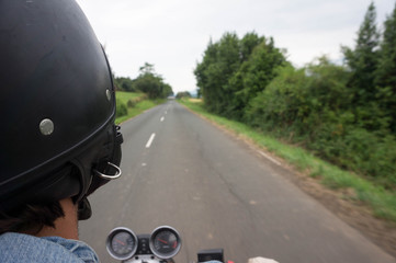 biker driving on a secondary road and enjoying the feeling of freedom