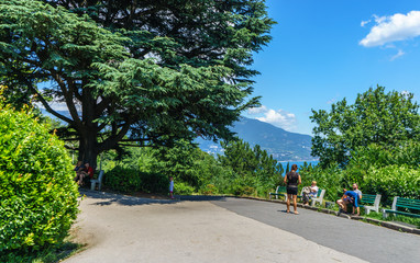 Tourists rest in the park of the Livadia Palace in Crimea