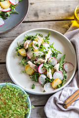 Fresh salad with radishes, potatoes, arugula and mackerel or tuna. diet concept