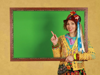 Middle aged female freak holds a picture frame in a studio