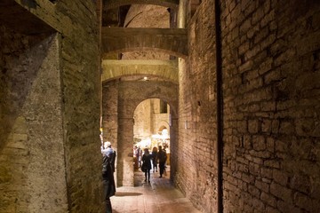 Stalls and people inside the ancient Rocca Paolina building in Perugia, Italy