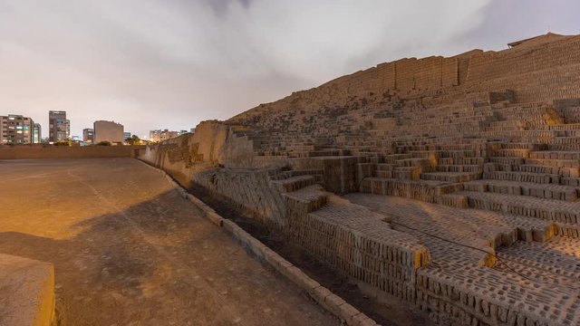 Pyramid of Huaca Pucllana day to night transition timelapse, pre Inca culture ceremonial building ruins in Lima, Peru. Clouds on a sky. Illumination is turning on