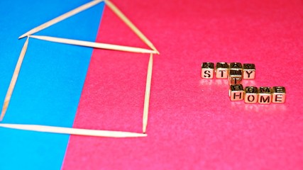 "Stay at home" with  Selected focus.
House of toothpicks with bead words "Stay at home". Selected focus. Concept. (Image contain certain grain or noise and soft focus when view at full resolution).