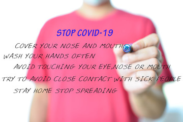Stop and stay safe from COVID-19 present by The hands of a man are writing instructions for safe...