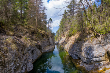 Fototapeta na wymiar small canyon at stuibenfaelle falls between rocks and trees in austria