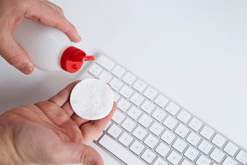 men´s  hands are cleaning the white keyboard