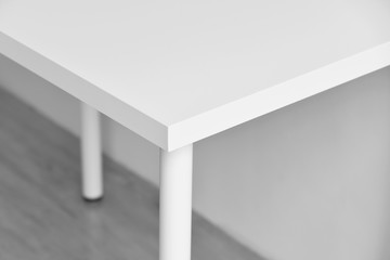 Table corner, Sharp desk edge, Home accident from furniture, White table with hard angle, Minimal style and copyspcae for wording.