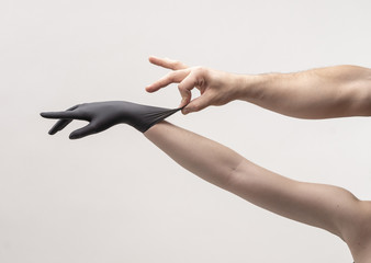 Female hand in a black silicone glove