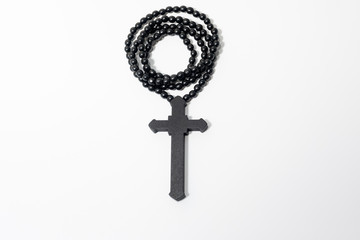 Wood rosary in white background. Brown wooden beads.