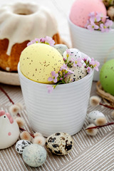 Easter table decorations with eggs, catkins and ceramic figurines.