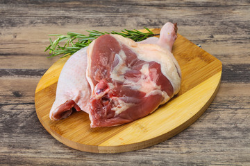 Raw duck leg served rosemary