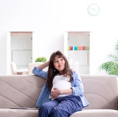 Pregnant woman relaxing on the sofa