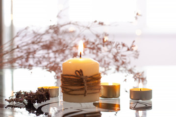 Aromatherapy flame closeup picture. Beautyful burning light light yellow creme vanilla candles with wooden background