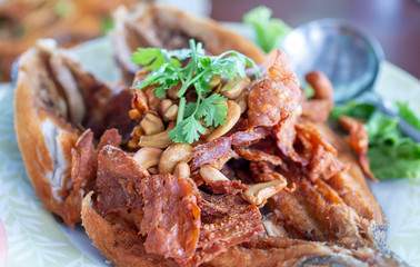 Deep fried Snapper topped with sweet fish sauce. Delicious Snapper topped with sauce. Asian...