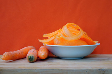 A bowl of fresh orange carrot ribbons