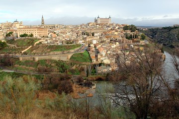 Fototapeta na wymiar Panorama of Old city of Toledo and river Tajo in the overcast day, Castilla La Mancha, Spain