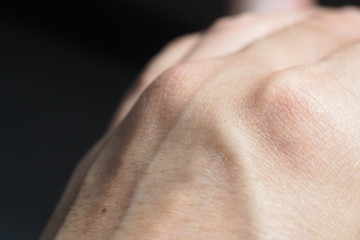 Closeup of the back side or dorsal side of hand with skin texture veins and knuckles for human hand anatomy. One of the most important organs for human daily activity and need special skin treatments