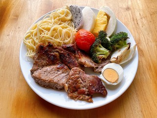 Pork chop steak and salad with spaghetti