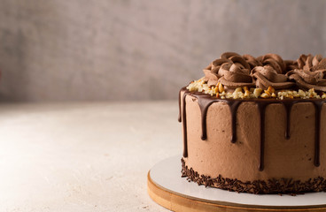 Chocolate cake on a gray background, horizontal photo.