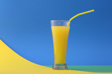 Glass of orange juice  on a blue background