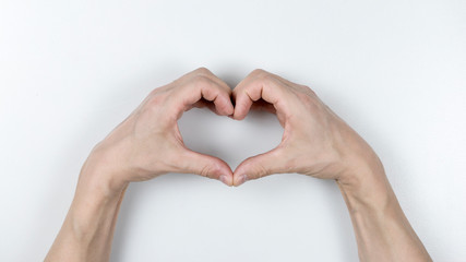 hands forming a heart on white background