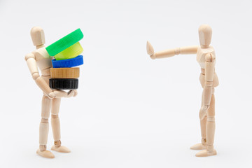 Wooden dummy refusing plastic plugs in front of a white background