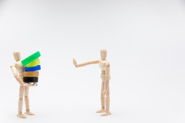 Wooden dummy refusing plastic plugs in front of a white background