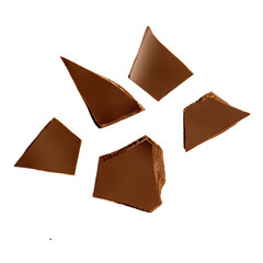 Dark chocolate pieces isolated on white background.  Chocolate bar chunks, shavings and cocoa crumbs Top view.