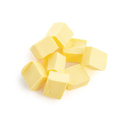 Butter pieces isolated on white background, top view. Fresh butter chunks  close up