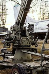 Fototapeta na wymiar old rusty Russian anti-aircraft gun in the museum outside