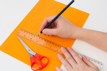 hand with pencil and ruler