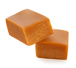 Homemade caramel pieces isolated on white background. Golden Butterscotch toffee candy caramel top view