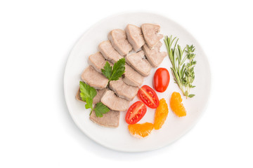 Boiled pork tongue with tomatoes and herbs isolated on white background. Top view, close up.