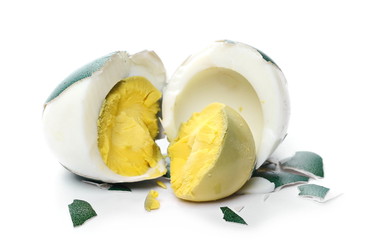 Boiled colored Easter egg broken in two halves isolated on white background