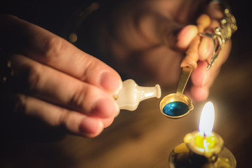 The withccraft. Wizard is holding in hand a magic potion close up.