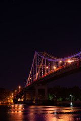 Night view of pedestrian bridge on Dnipro in Kiev Ukraine
