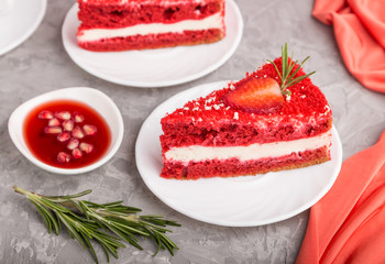 Homemade red velvet cake with milk cream and strawberry on a gray concrete background. side view, selective focus.
