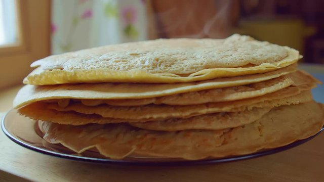 Chef cook put by spatula the steam yummy pancake on stack plate. Slowmo closeup