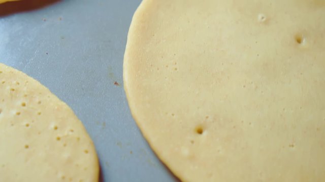 Three raw flapjack, tortilla, pancakes, bake fry in pan. Cooking. Close up.