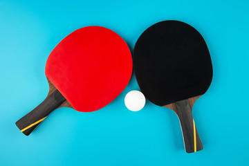 tennis rackets and a ping-pong ball on a blue background