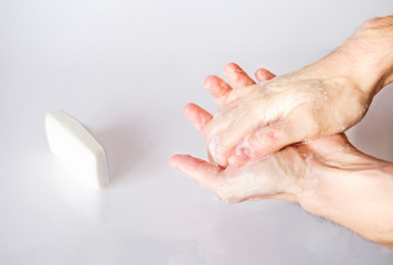 Obraz na płótnie Canvas Hand hygiene. A man washes his hands with soap, antibacterial protection