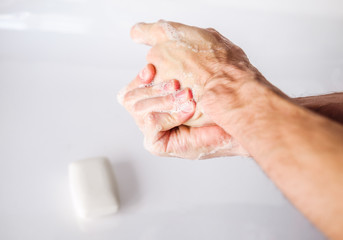 Fototapeta premium Hand hygiene. A man washes his hands with soap, antibacterial protection