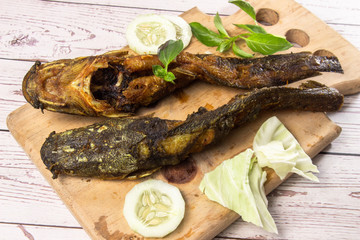 Deep fried catfish, on wooden background.