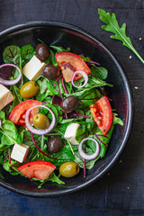 healthy salad
olives, lettuce, tomato and cheese
feta (greek salad, tasty vegetables snack) menu concept background. top view. copy space for text
