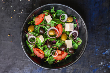 healthy salad
olives, lettuce, tomato and cheese
feta (greek salad, tasty vegetables snack) menu concept background. top view. copy space for text