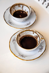 A cup of Turkish coffee, traditionally using for fortune telling. traditional porcelain turkish coffee cup. white background